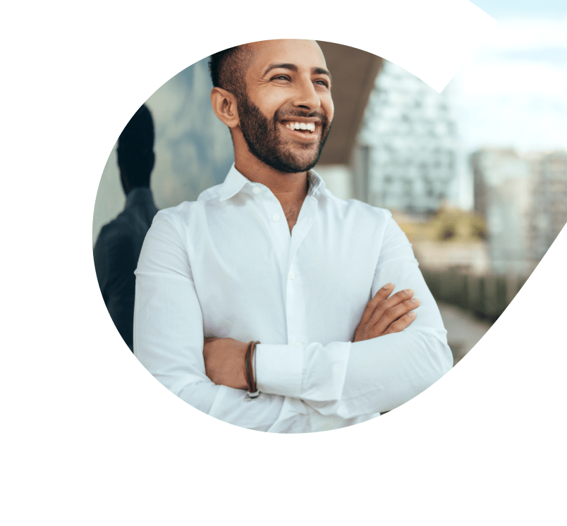 Businessman smiling. He is looking through a bay window